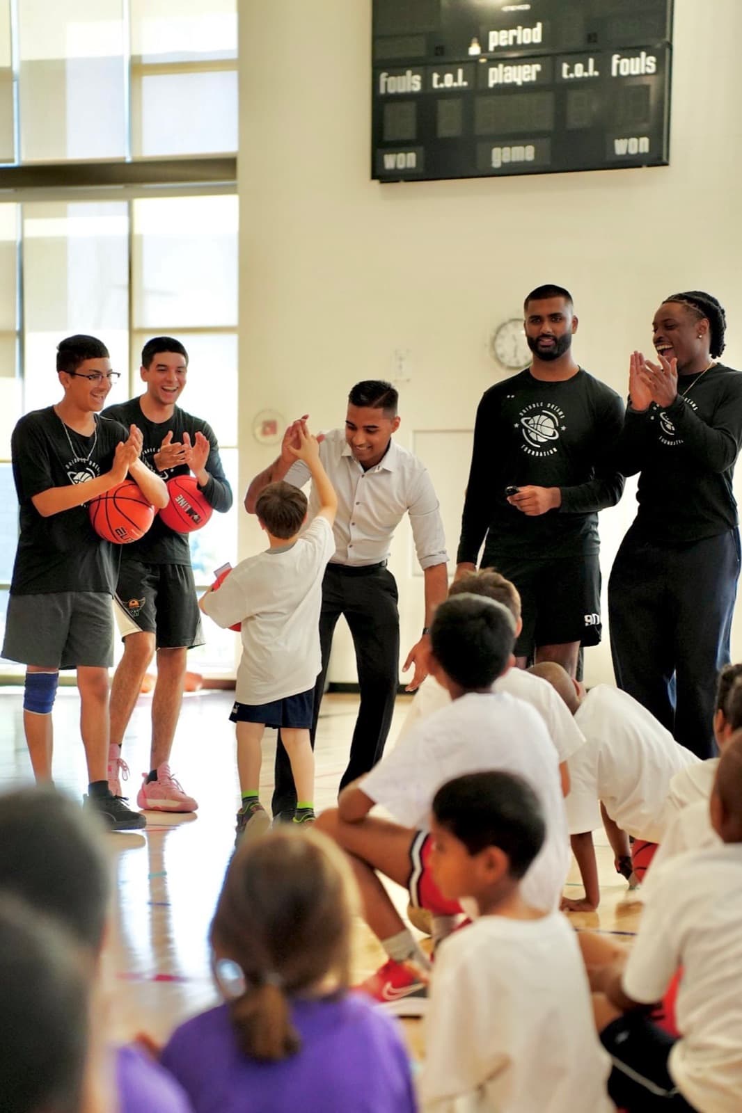 Adil Khalqi cheering on a Milton youth basketball camp