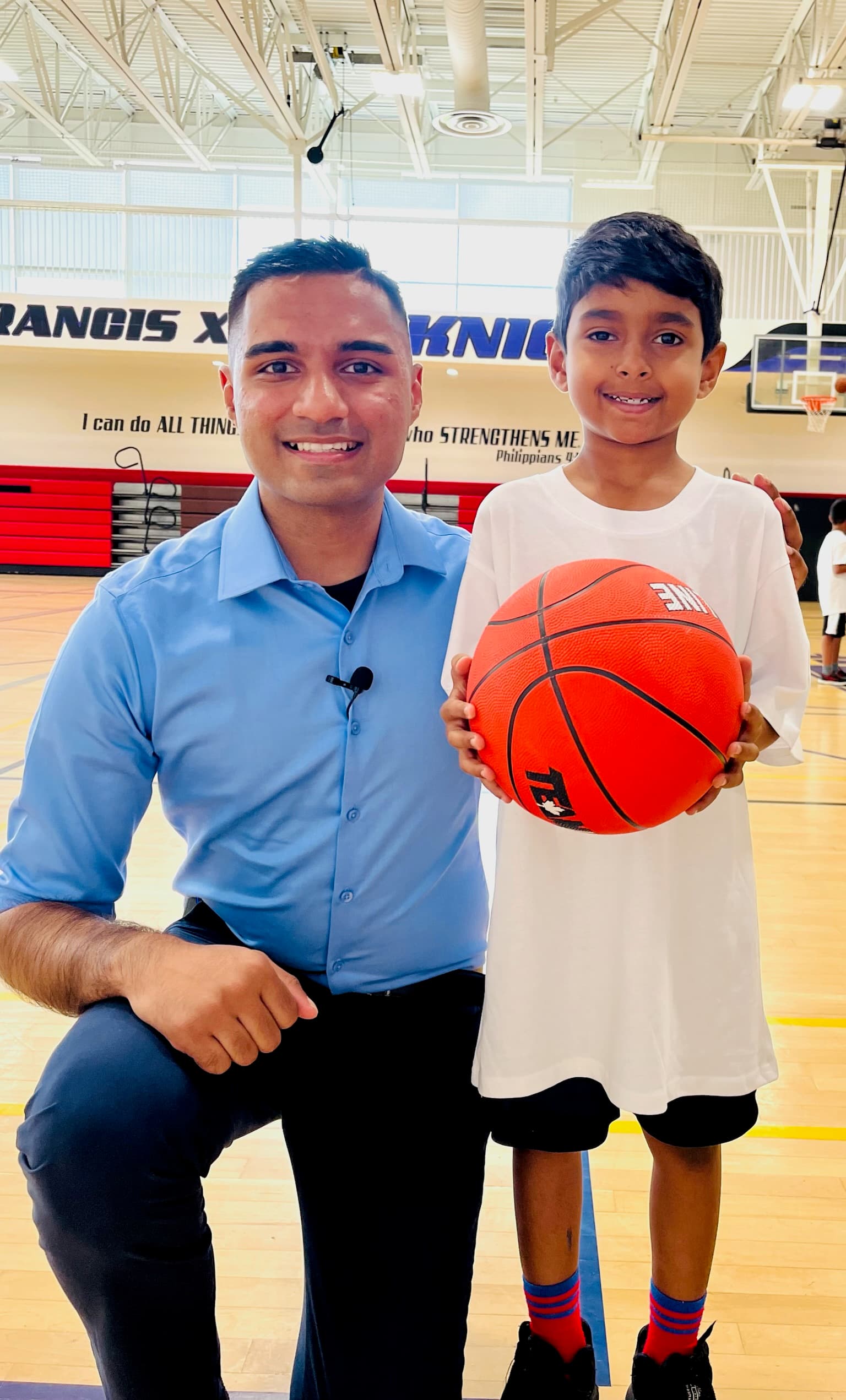 Adil Khalqi with a young basketball player at a Milton recreation centre